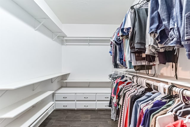 walk in closet with a baseboard heating unit