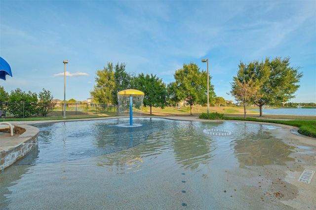 view of swimming pool with a water view