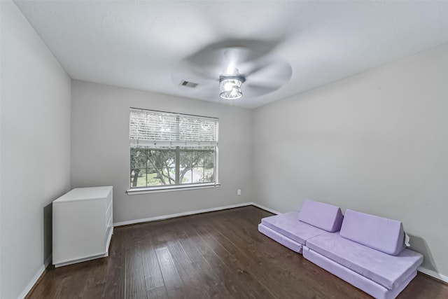 unfurnished room featuring ceiling fan and dark hardwood / wood-style flooring