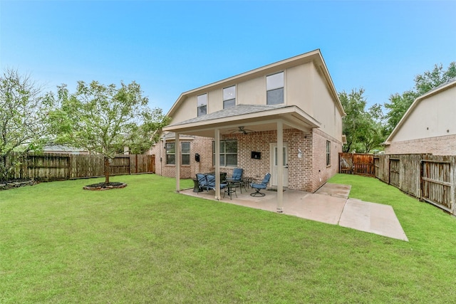 rear view of property featuring a patio, ceiling fan, and a lawn