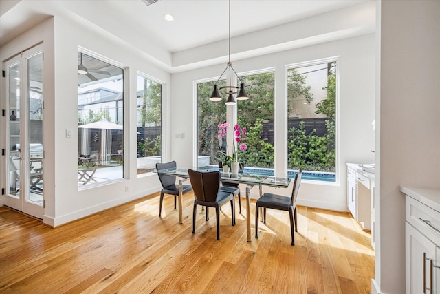 dining area featuring light wood-type flooring and a chandelier