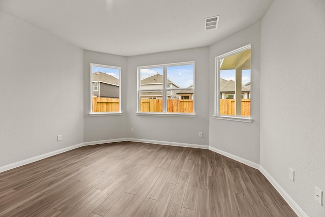 unfurnished room with wood-type flooring