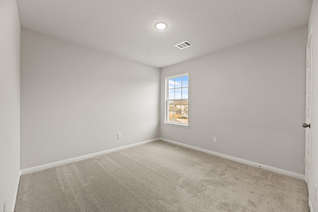 empty room with light colored carpet