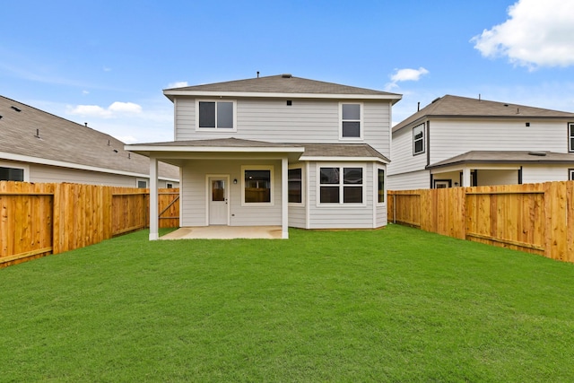 back of house featuring a yard and a patio