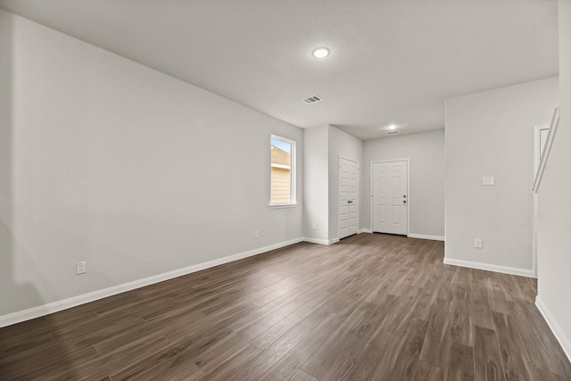 empty room with dark hardwood / wood-style floors