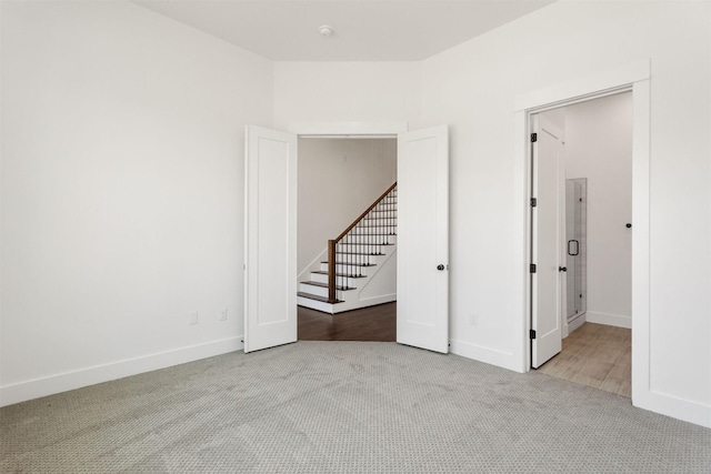 spare room featuring light carpet