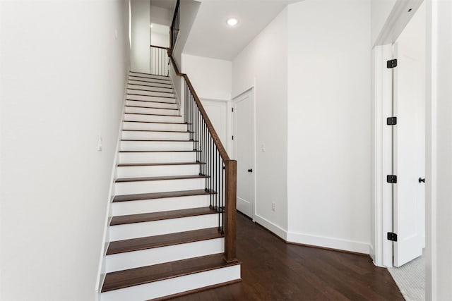 stairs featuring hardwood / wood-style flooring