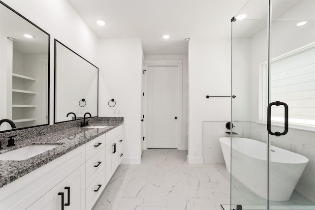 bathroom featuring vanity and a tub to relax in