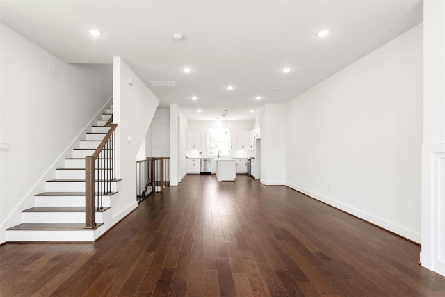 unfurnished living room featuring dark hardwood / wood-style floors