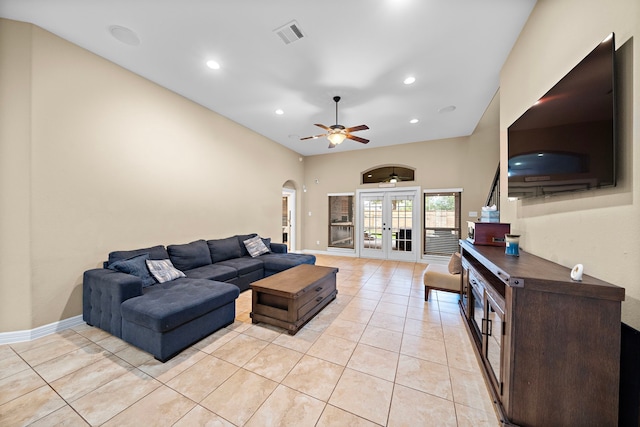 living room featuring ceiling fan, light tile patterned floors, and french doors