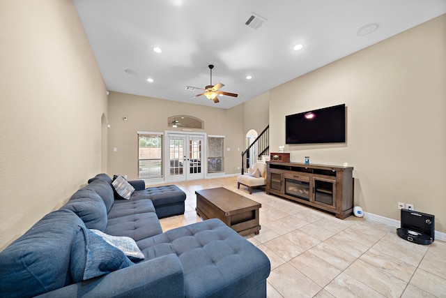 tiled living room with ceiling fan and french doors