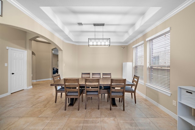 tiled dining room with a notable chandelier, a raised ceiling, and ornamental molding