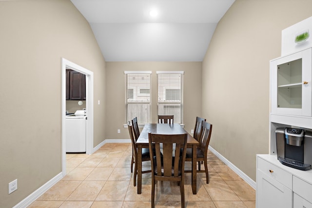 tiled dining space featuring lofted ceiling