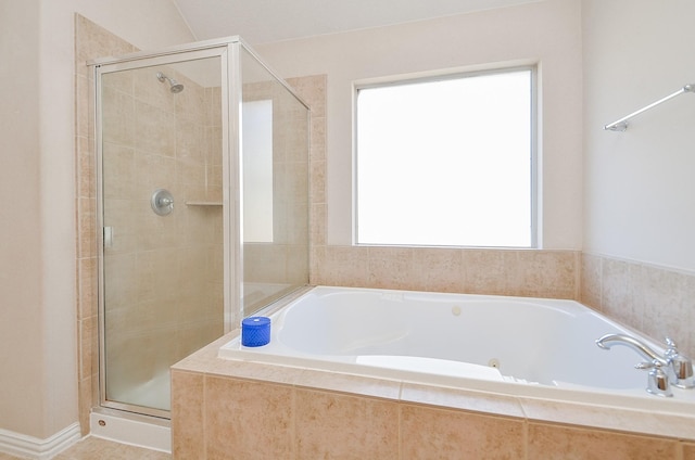 bathroom featuring separate shower and tub