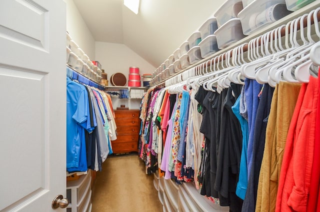 spacious closet featuring carpet and vaulted ceiling