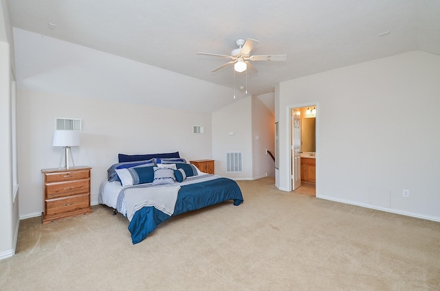 bedroom featuring ensuite bath, ceiling fan, light colored carpet, and vaulted ceiling