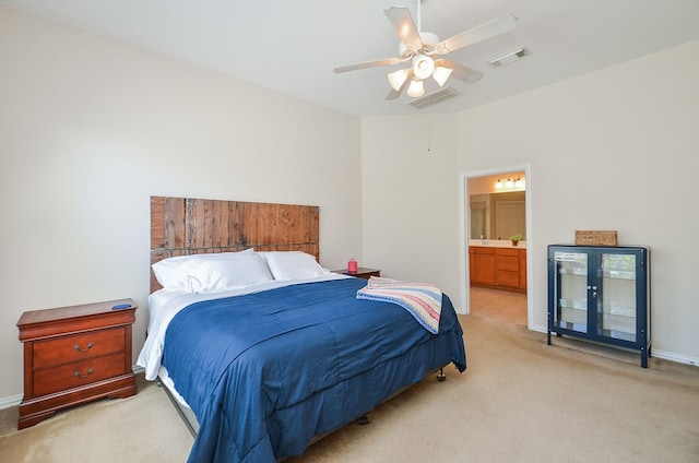 carpeted bedroom with ceiling fan and ensuite bathroom