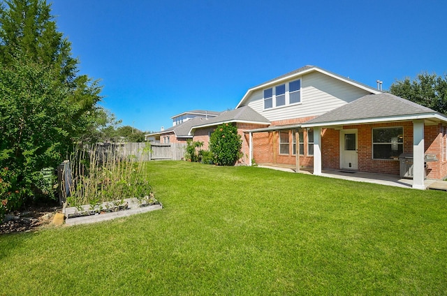 rear view of house with a yard