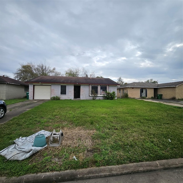 ranch-style house featuring a garage and a front lawn