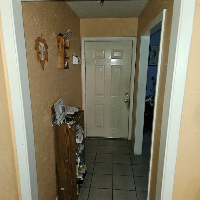 doorway with dark tile patterned flooring