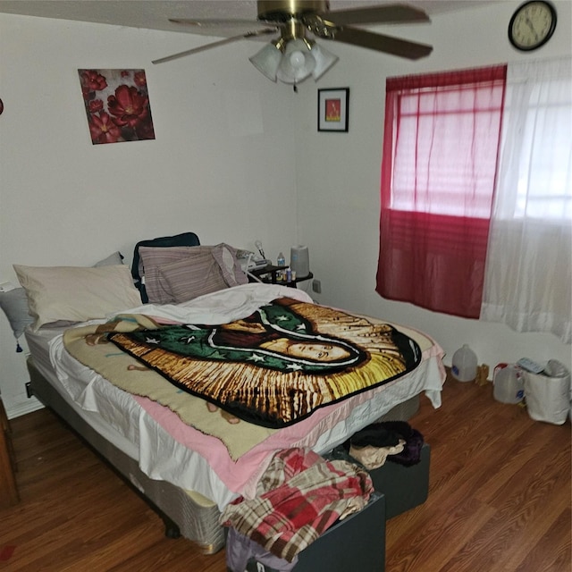 bedroom featuring ceiling fan and hardwood / wood-style flooring