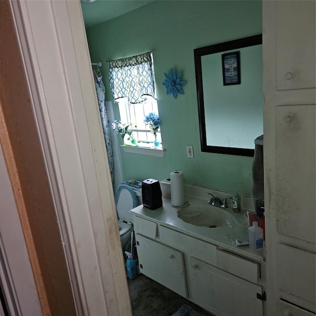 bathroom featuring vanity and toilet