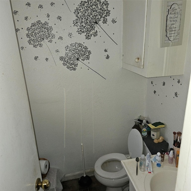 bathroom featuring tile patterned floors, toilet, and sink