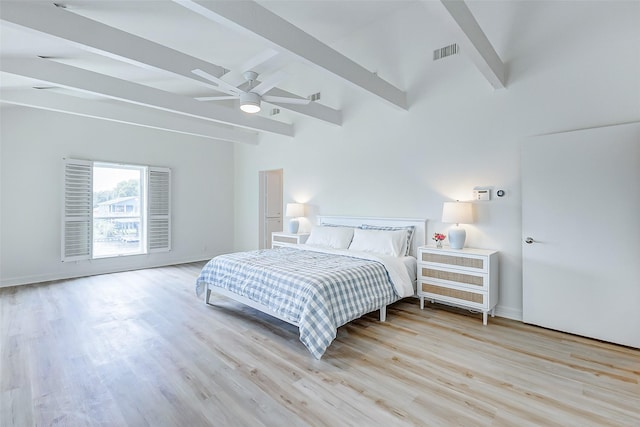 bedroom with beamed ceiling, ceiling fan, and light wood-type flooring