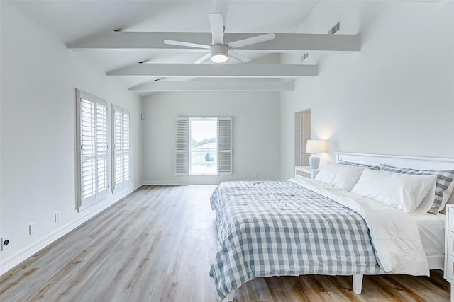 bedroom with vaulted ceiling with beams, ceiling fan, light hardwood / wood-style floors, and multiple windows