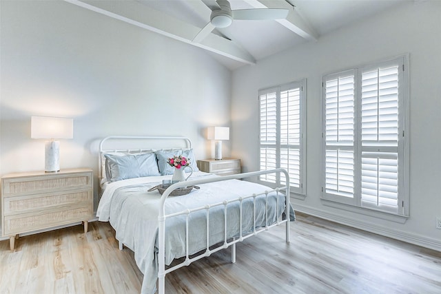 bedroom featuring ceiling fan, light hardwood / wood-style flooring, and lofted ceiling