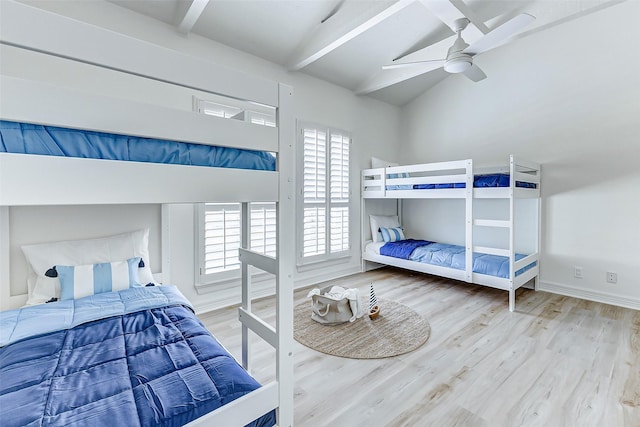 bedroom featuring hardwood / wood-style floors, vaulted ceiling with beams, and ceiling fan