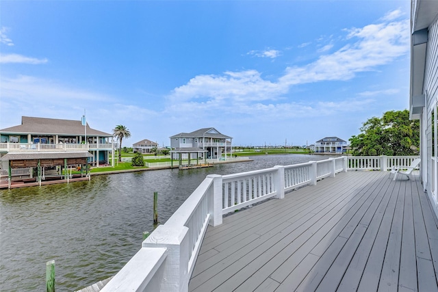 wooden terrace with a water view and a dock