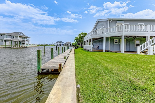 dock area featuring a yard and a water view