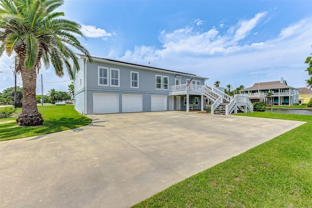 view of front of property with a front yard and a garage