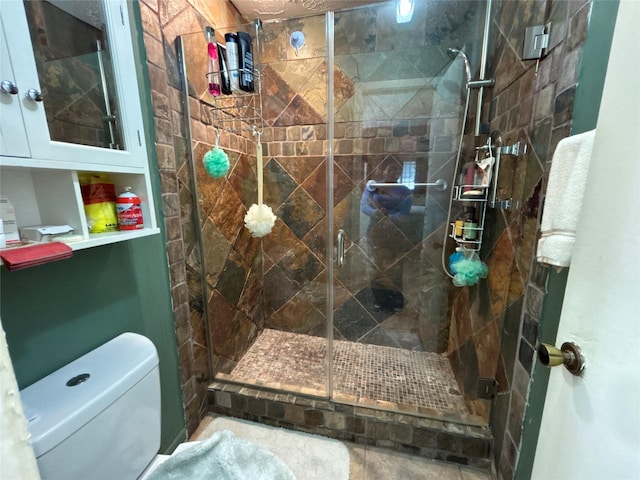 bathroom with tile patterned floors, toilet, and walk in shower