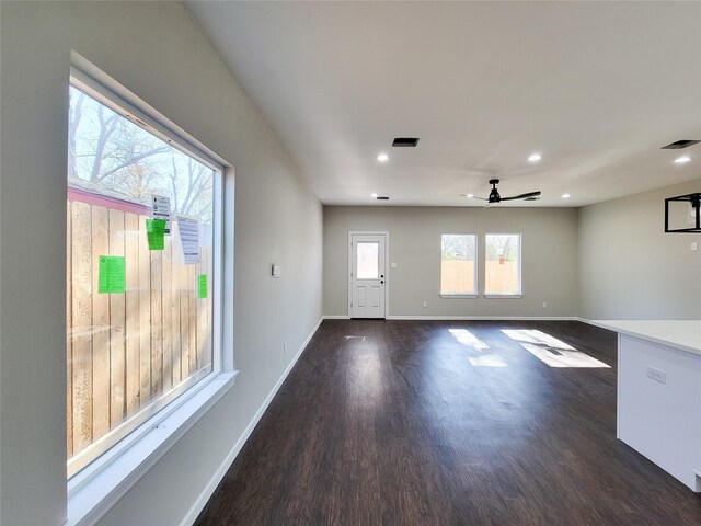 unfurnished room featuring ceiling fan and dark wood-type flooring