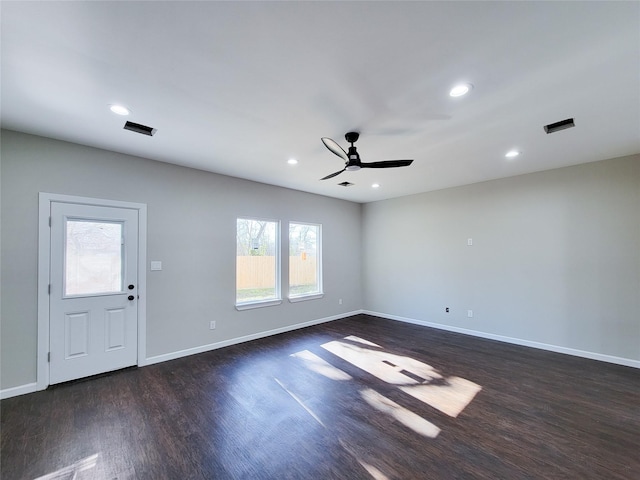 interior space featuring plenty of natural light, dark wood-type flooring, and ceiling fan