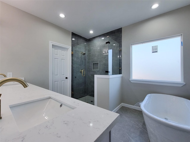 bathroom with vanity and independent shower and bath