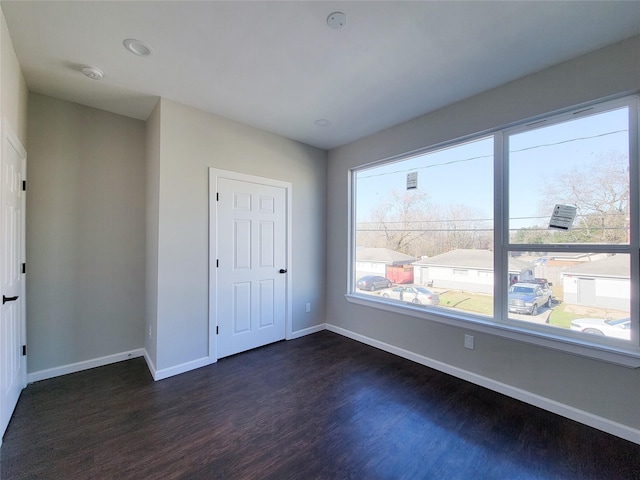 unfurnished bedroom with dark hardwood / wood-style floors