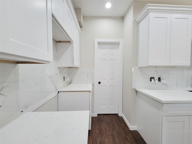 kitchen featuring decorative backsplash, white cabinetry, and dark hardwood / wood-style floors