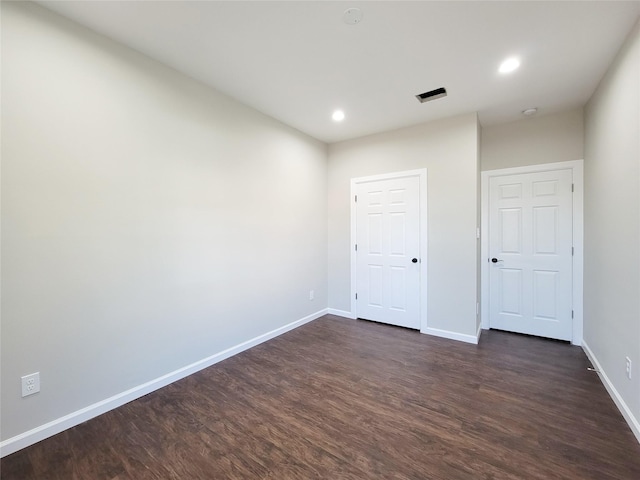 unfurnished bedroom with dark hardwood / wood-style flooring