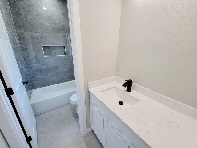 full bathroom featuring tiled shower / bath, tile patterned flooring, vanity, and toilet