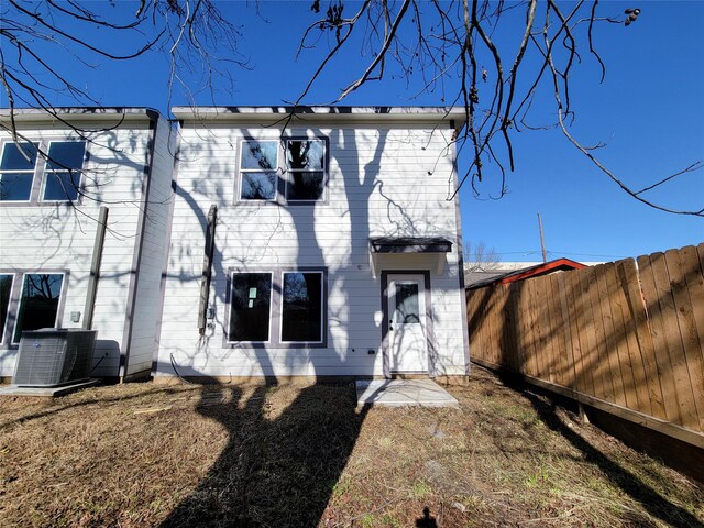 rear view of house with central AC unit