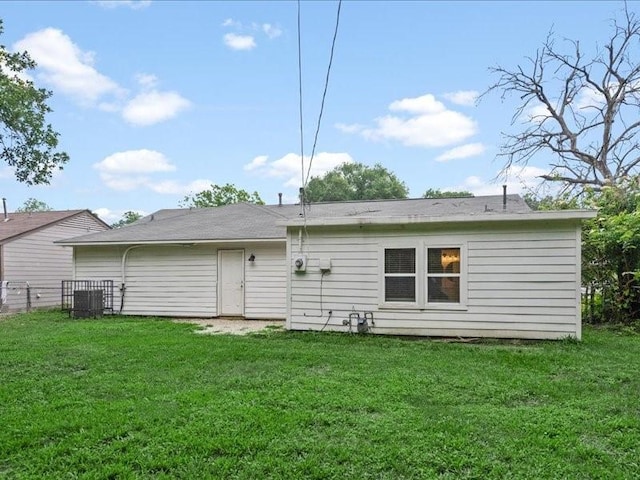 back of house with a lawn