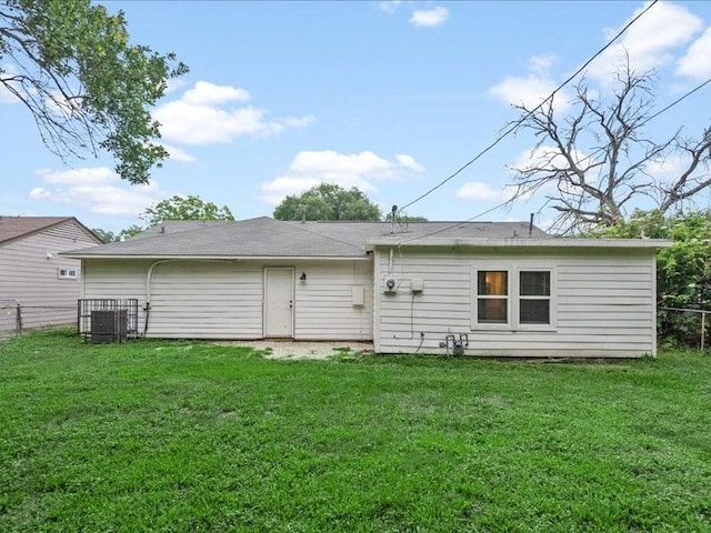 rear view of property featuring a yard