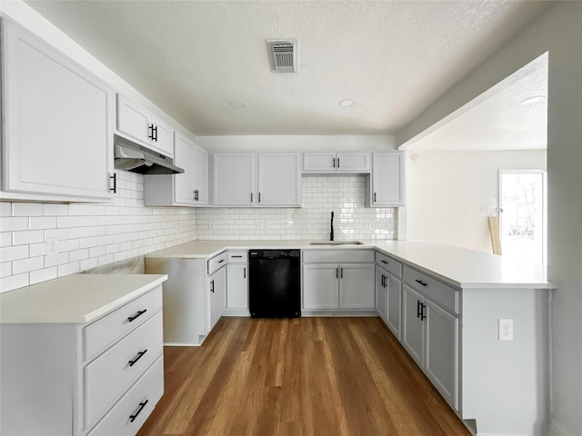 kitchen with white cabinetry, sink, black dishwasher, and dark wood-type flooring