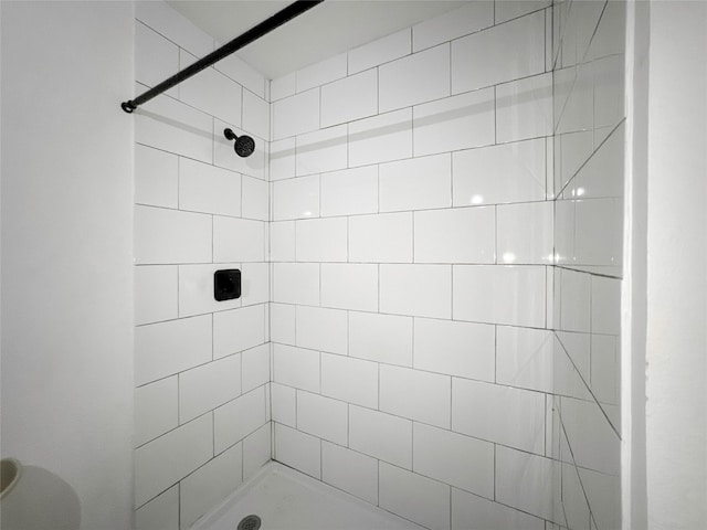 bathroom with a tile shower