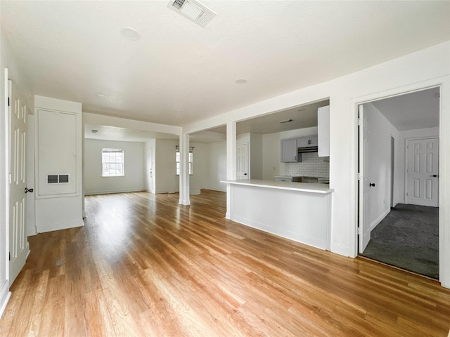 unfurnished living room with light wood-type flooring