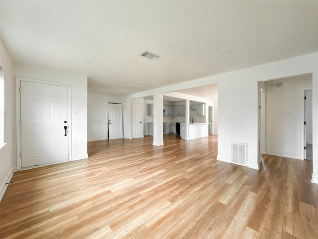 unfurnished living room with light wood-type flooring