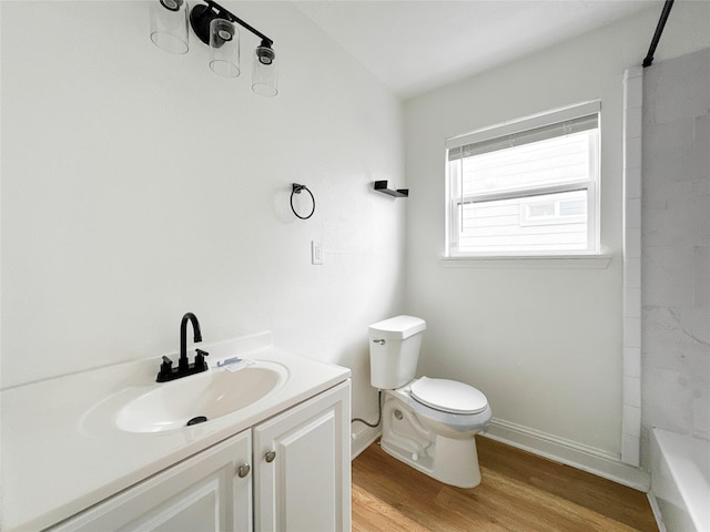 bathroom featuring vanity, hardwood / wood-style floors, and toilet